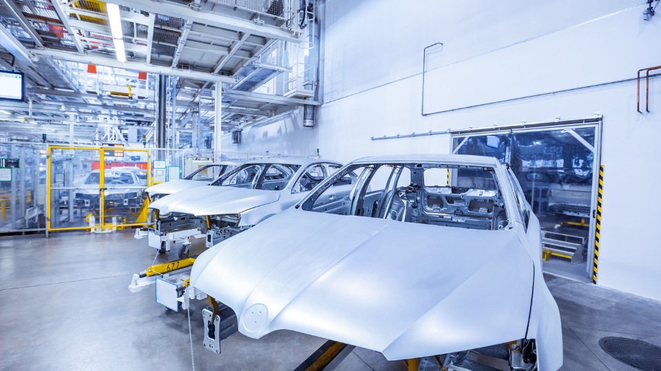 Cars staged for paint in automotive plant