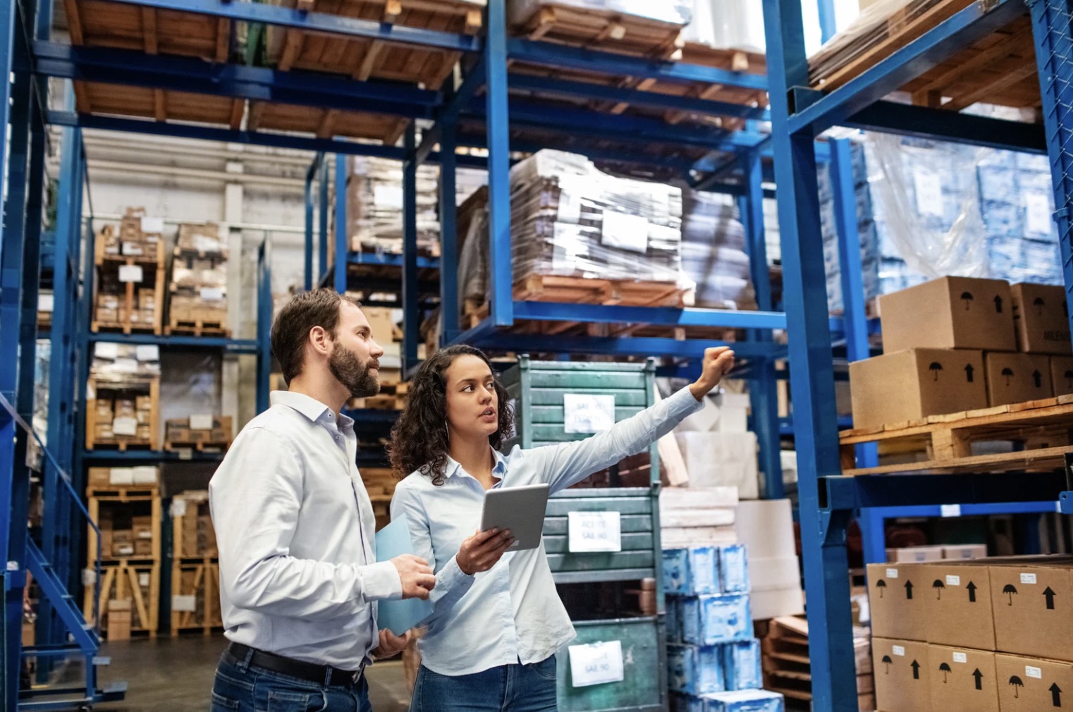 Workers discussing inventory in warehouse Workers discussing inventory in warehouse